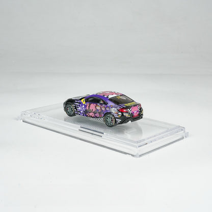 A miniature model car on a display stand, featuring vibrant cartoon graphics with a purple and black color scheme, creating a playful and cheerful vibe.