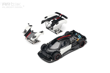 A 1:64 scale model of a black and white Pagani Zonda R sports car, shown with its front and rear body panels separated on stands against a white background. The ARBox brand logo is visible in the top left corner.