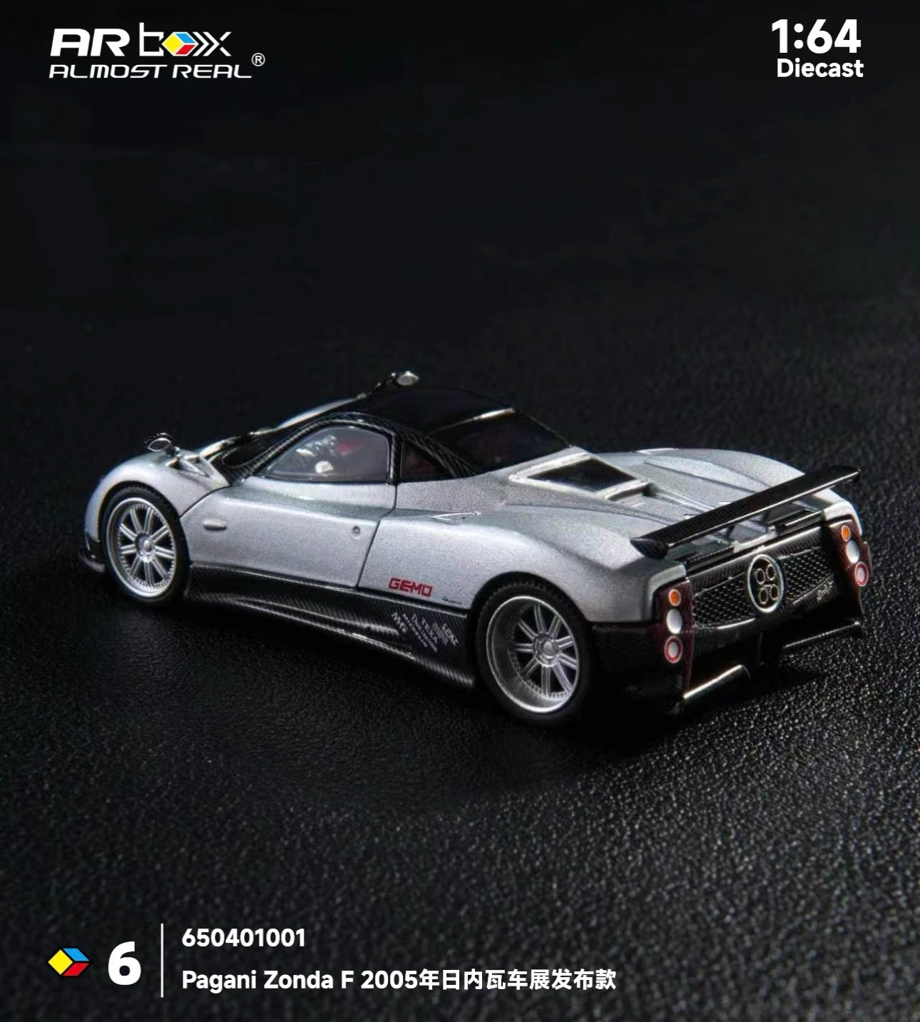 A silver Pagani Zonda F 1:64 scale diecast model by Artbox Almost Real, showcasing detailed design against a dark textured background.