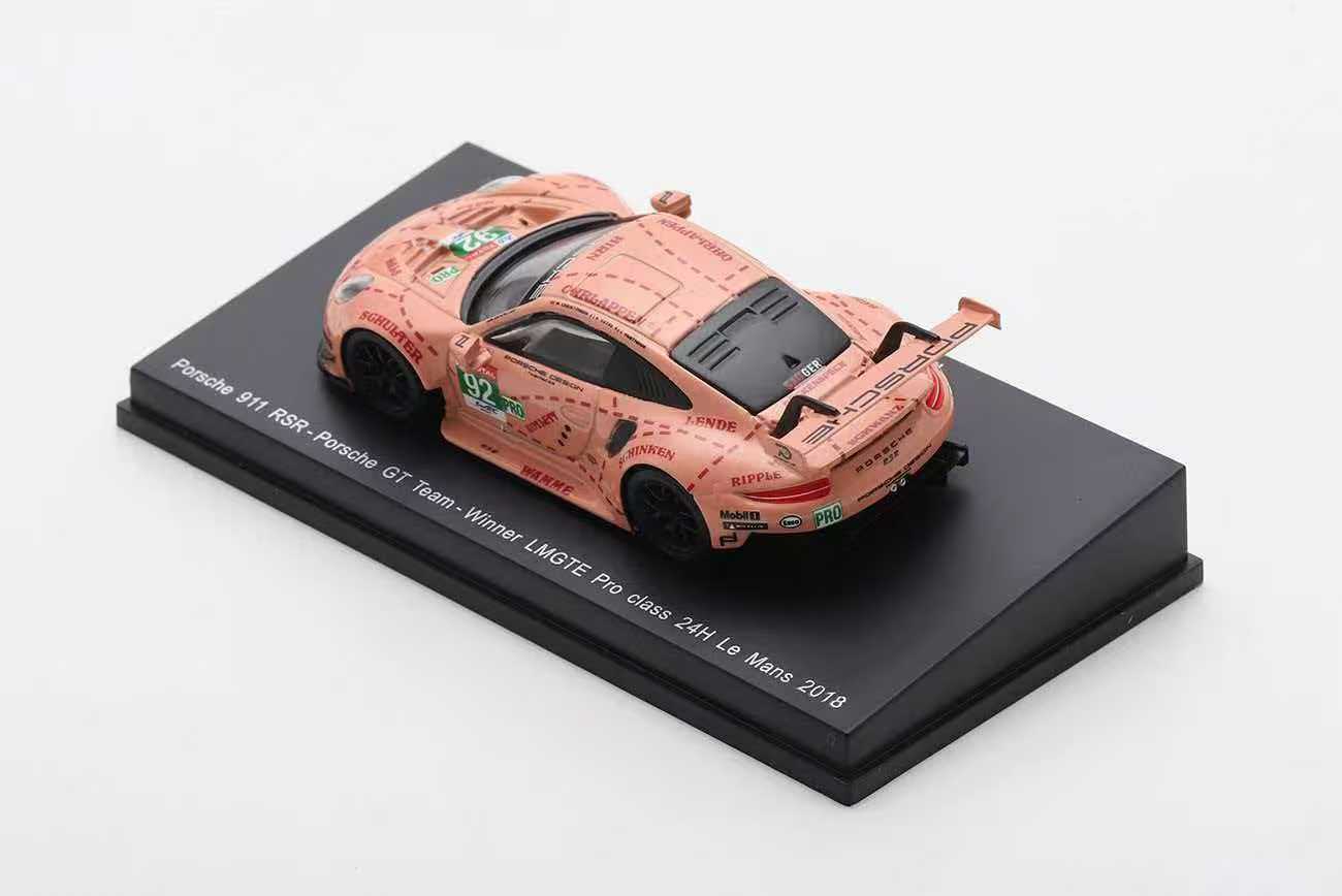 Model of a pink Porsche sports car on a black base with text