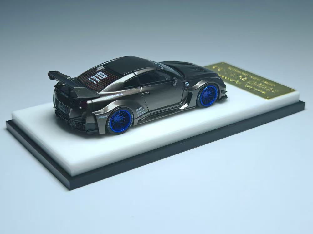 Model car on a display stand with a gray background