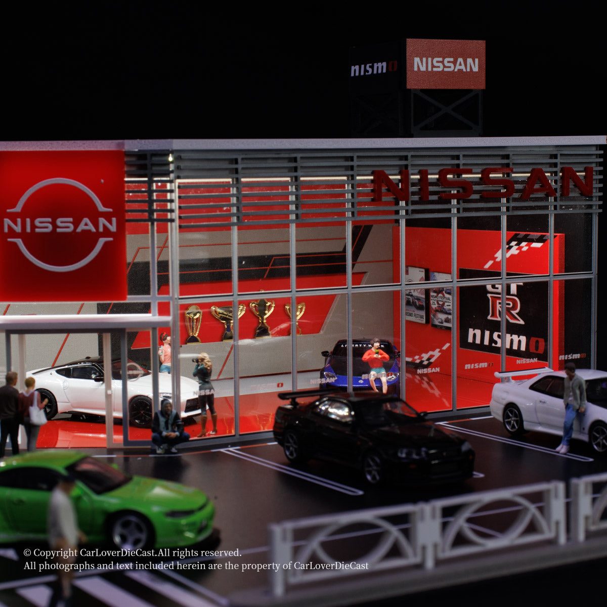 Model of a Nissan showroom with various cars and people around