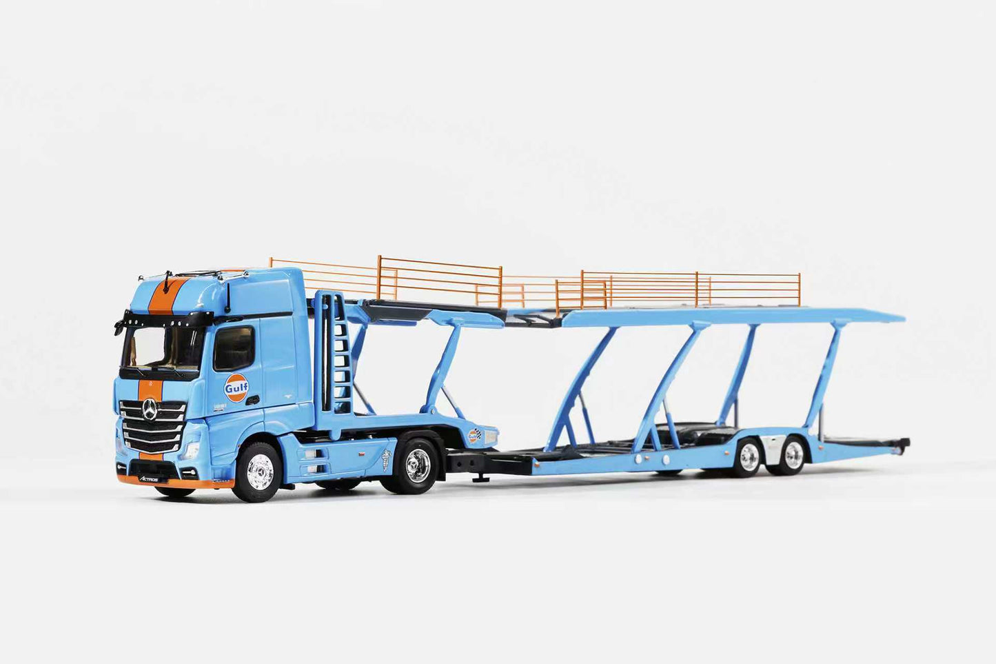 Model of a blue car transporter truck on a white background