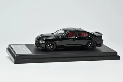 Black car model on a display stand with a white background