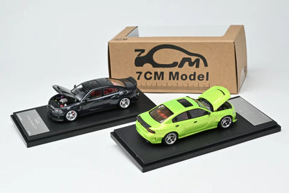Two model cars on display with a cardboard box labeled '7CM Model' in the background.