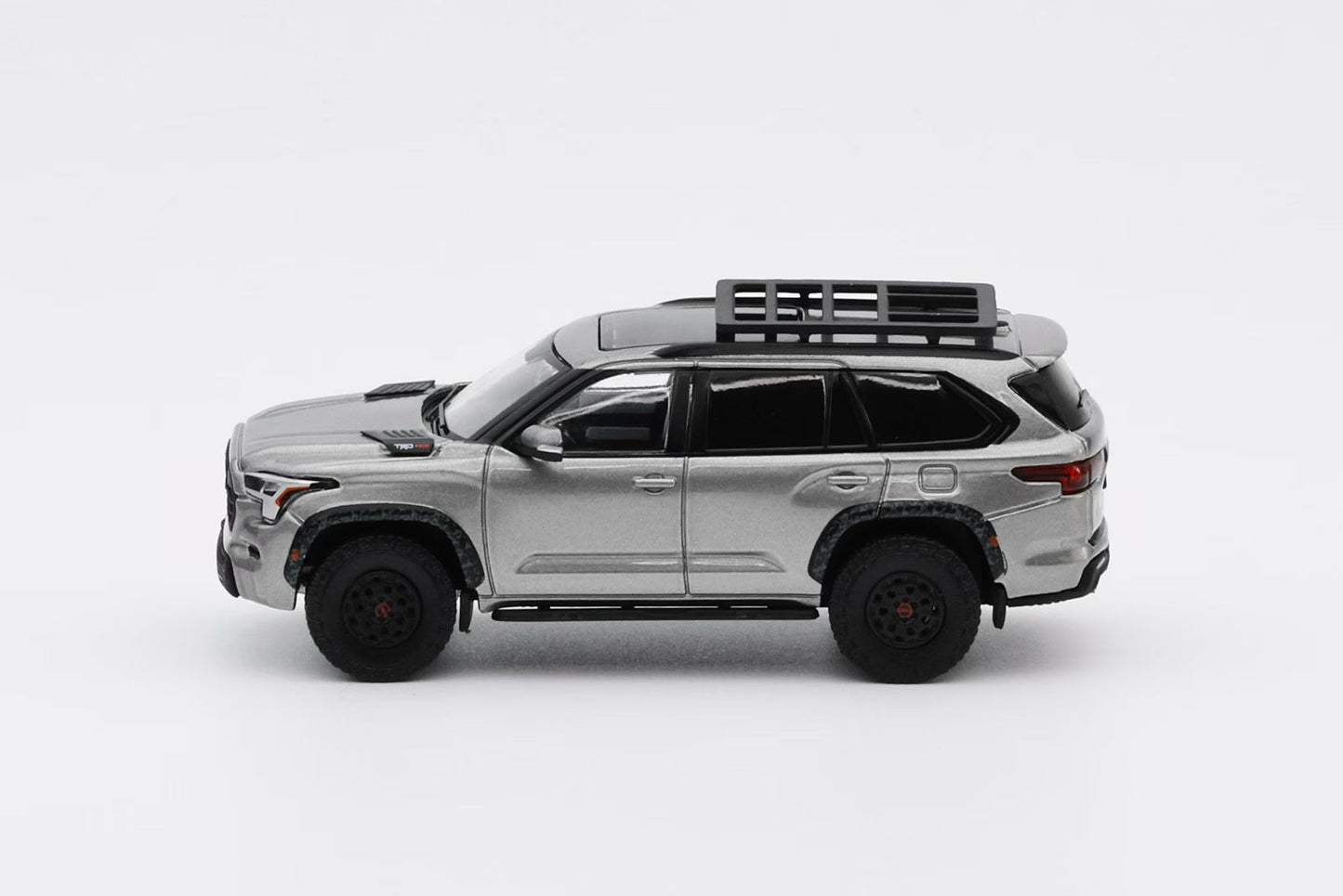Model SUV with roof rack on a white background