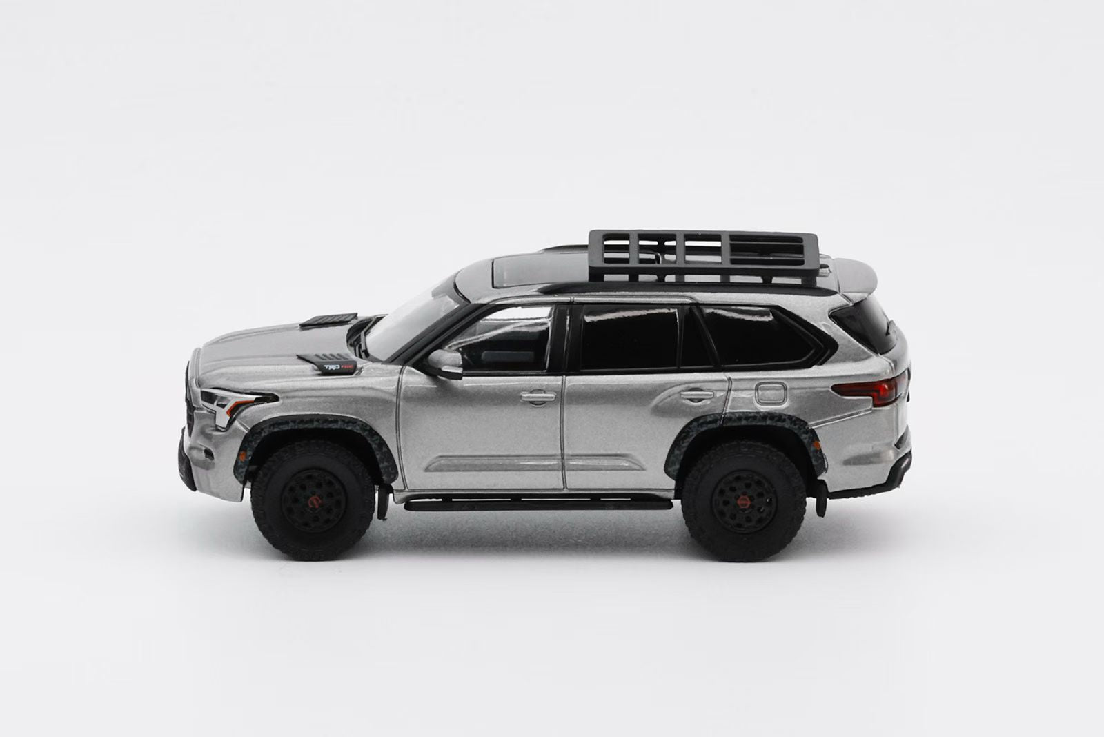 Model SUV with roof rack on a white background