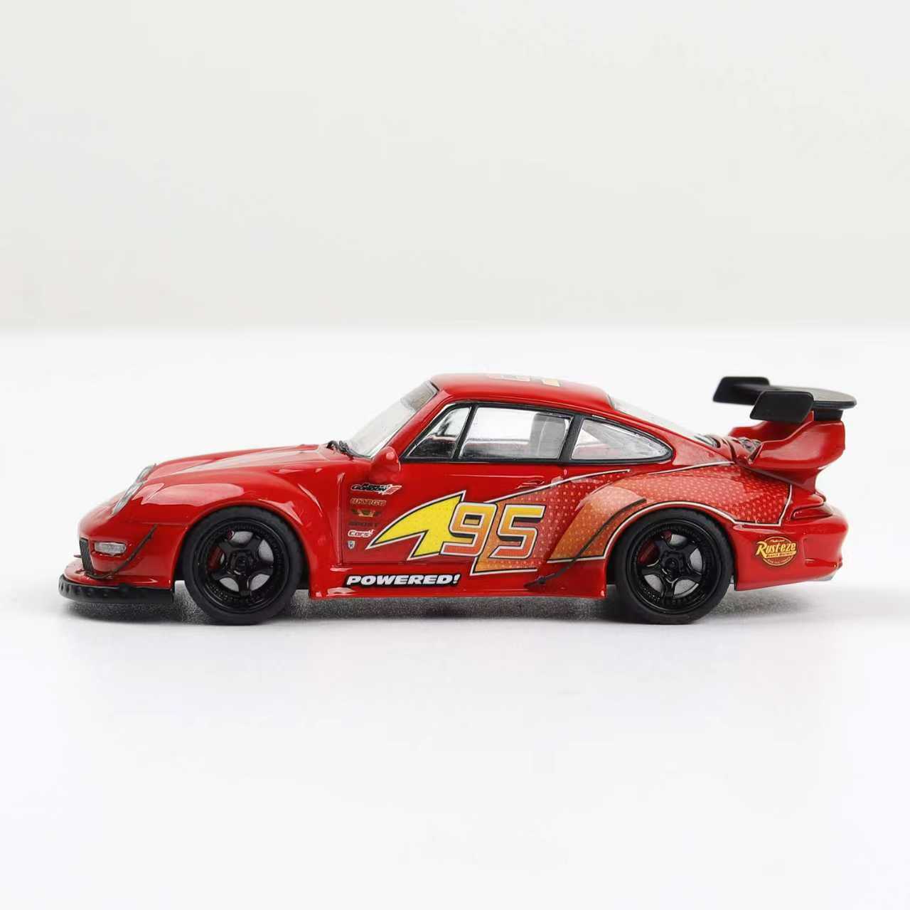 Red toy car with black wheels on a white background