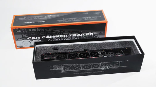 Model car carrier trailer in open packaging with branding GCD on a white background