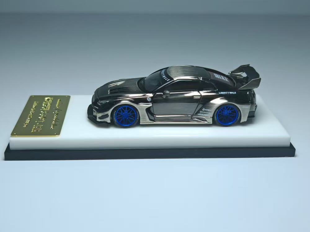 Model car on a white platform with a gray background