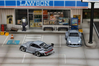Model cars in front of a Lawson convenience store.