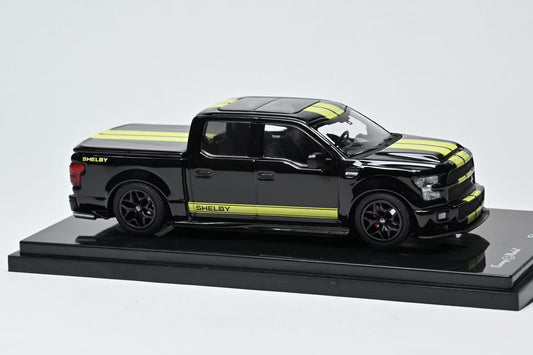 Black and yellow stripe Ford Shelby F150 model truck on a display stand with a white background