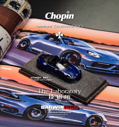 Blue toy car on a black stand with Chopin and DarwinPro branding in the background.