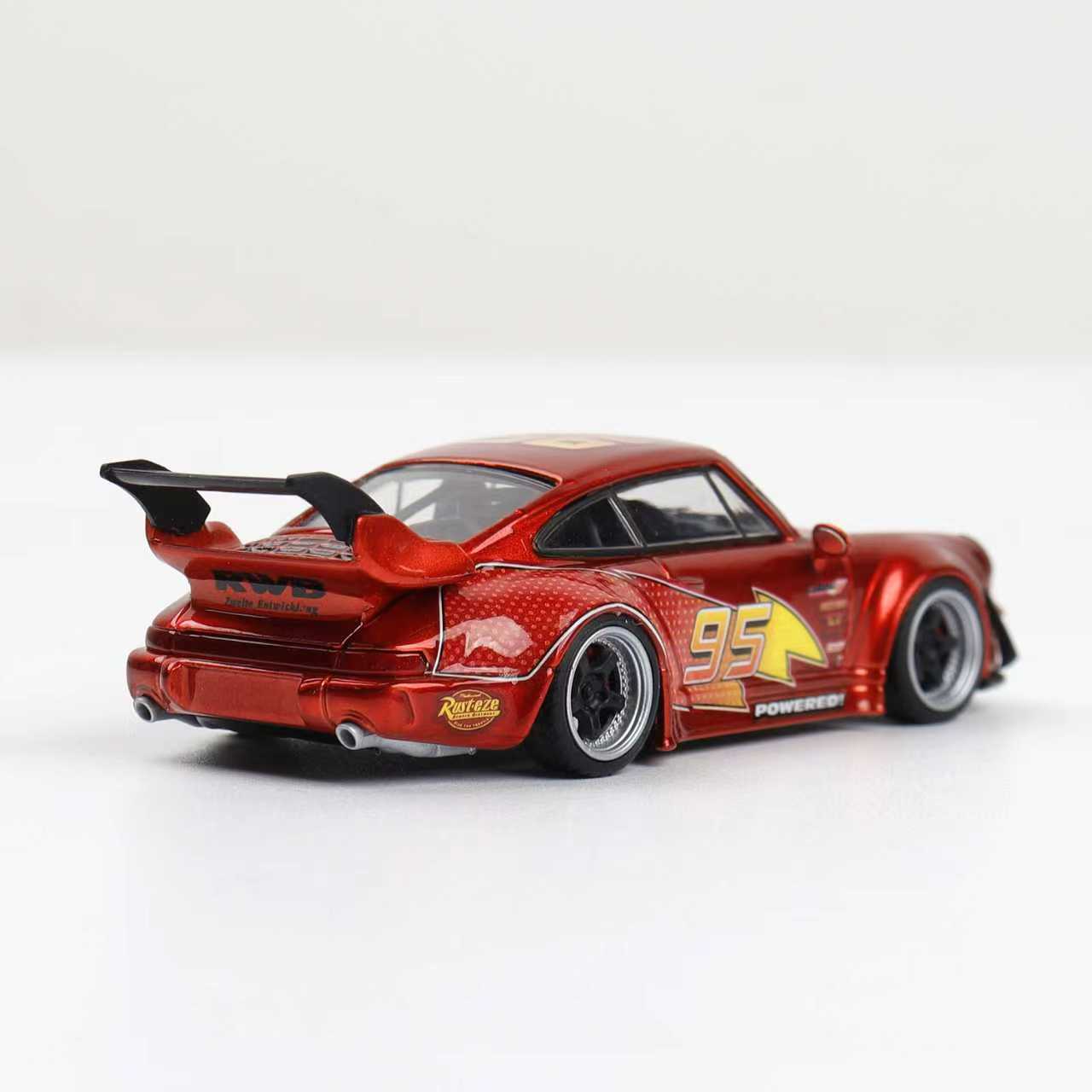 Red model car with black and yellow details on a white background