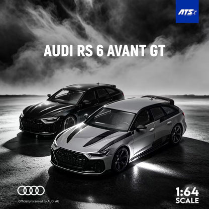 Two scale model cars of the Audi RS 6 Avant GT in a 1:64 scale kit by ATS. The image shows the cars in a dramatic black and white moody setting with smoke and wet pavement, featuring the Audi logo and ATS logo.