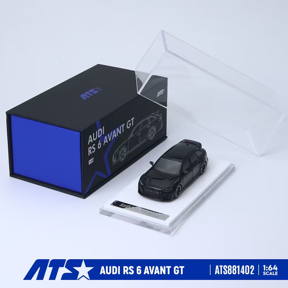 ATS 1:64 scale model car of the Audi RS 6 Avant GT, shown in a black finish on a clear display base next to its black and blue packaging box.