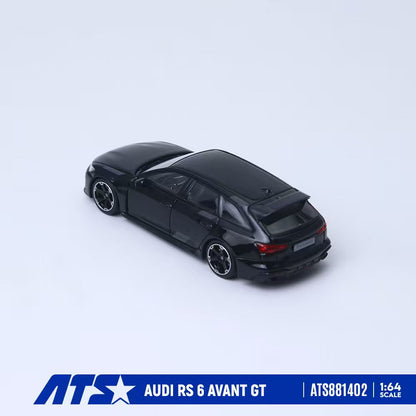 A black 1:64 scale diecast model car of an Audi RS 6 Avant GT, shown from a three-quarters rear angle on a light gray background with a blue brand banner at the bottom.