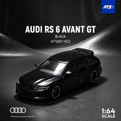 A black 1:64 scale model car of the Audi RS 6 Avant GT, shown on a dark textured surface with dramatic lighting. The image includes branding for ATS and an official license by Audi AG.