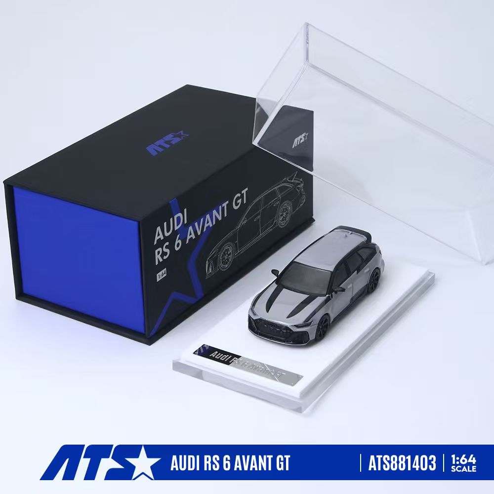 ATS 1:64 scale model car of the Audi RS 6 Avant GT, shown with its black and blue retail packaging box, a clear display stand, and an acrylic cover on a white background.
