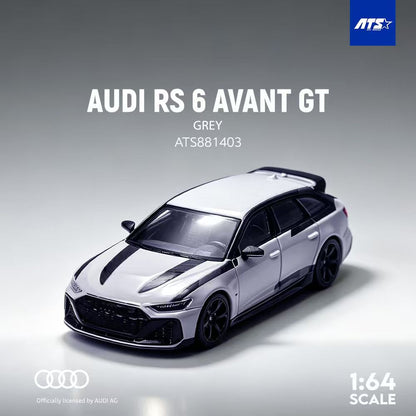 A 1:64 scale model car of the grey Audi RS 6 Avant GT, featuring black racing stripes on the hood and roof, shown on a grey gradient background with ATS and Audi branding.