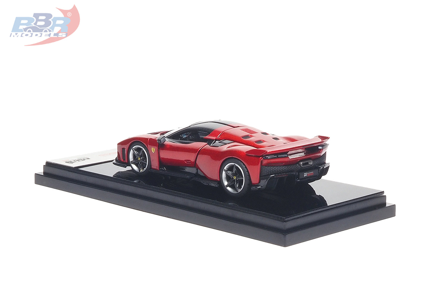 1:64 scale Ferrari F80 diecast model in Rosso Corsa red displayed on a premium black presentation base, shown from the rear three-quarter angle. Features carbon fiber accents, sculpted aerodynamic bodywork, realistic alloy wheels, detailed rear diffuser and taillights, making it a premium collectible for Ferrari enthusiasts and diecast model collectors