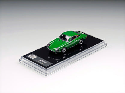 A green die-cast model car displayed on a black base inside a clear acrylic case, photographed on a clean light gray studio background.