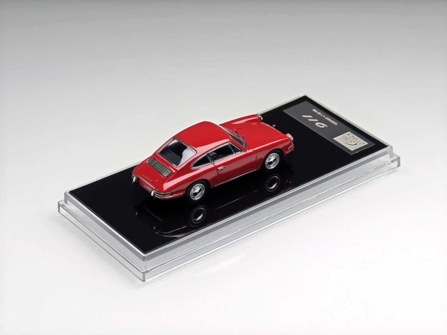 A red die-cast model car displayed on a black base inside a clear acrylic case, photographed on a clean light gray studio background.