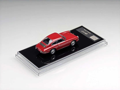 A red die-cast model car displayed on a black base inside a clear acrylic case, photographed on a clean light gray studio background.