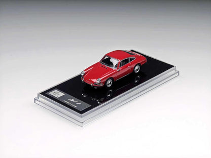 A red miniature model car displayed on a black base inside a clear acrylic case, photographed on a clean light gray studio background.
