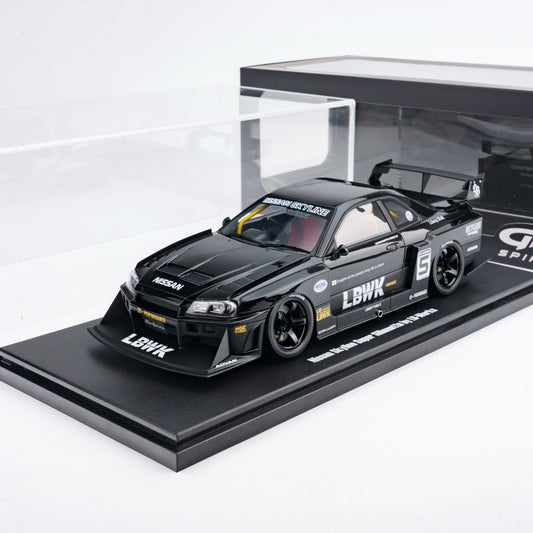 Black model car on a display stand with visible branding