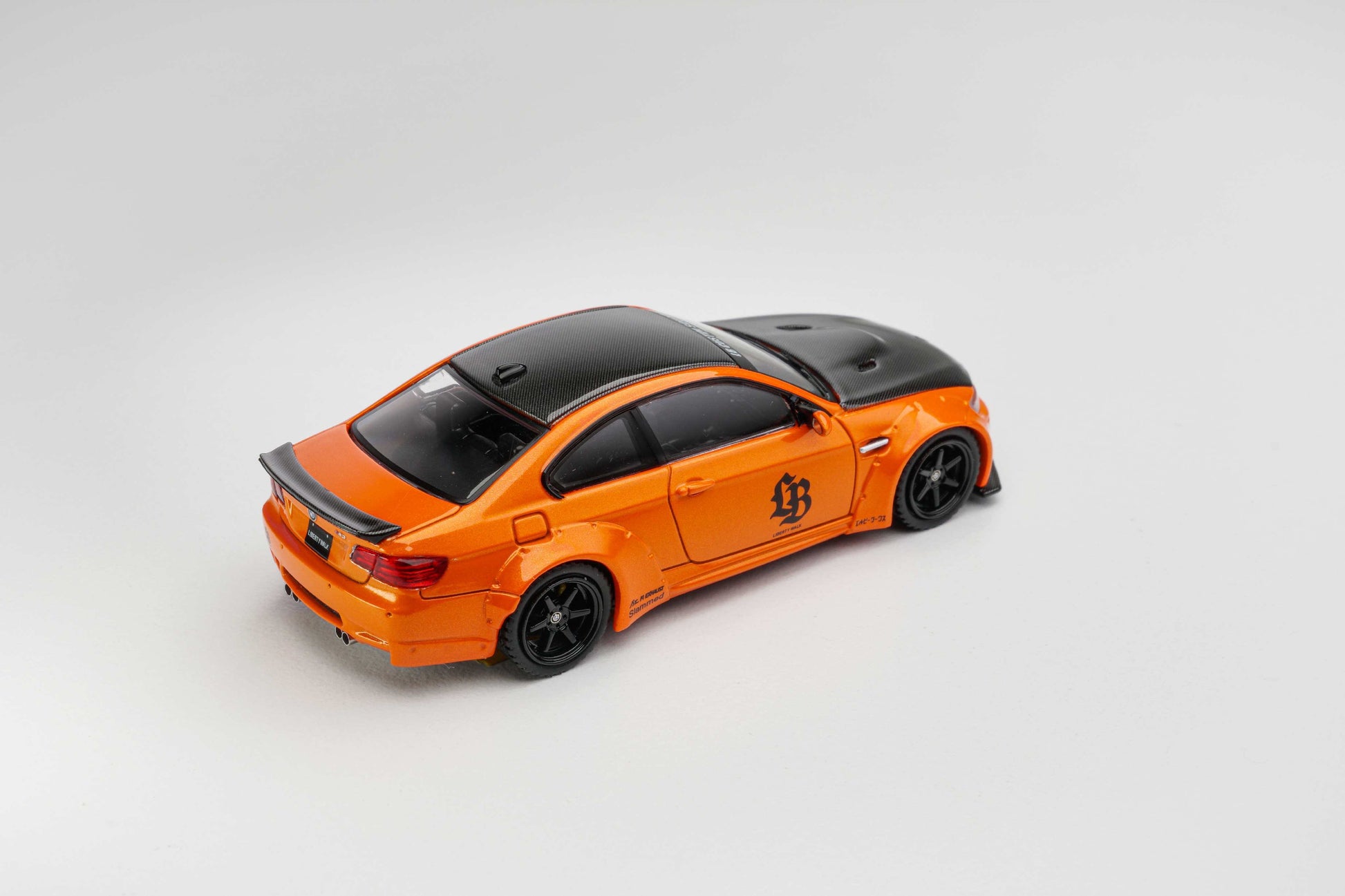 Orange model car with black roof on a gray background