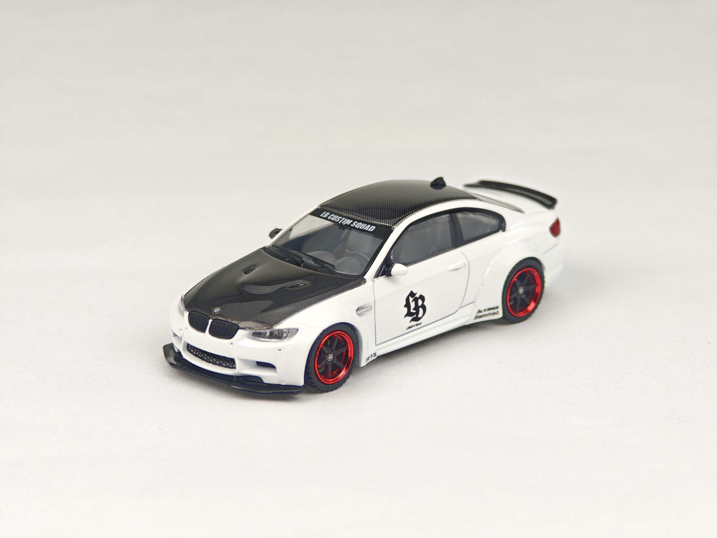Model car with black and red accents on a white background