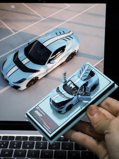 GLAMCRAFT 1:64 Ferrari 812 Competizione Light Blue with White Stripes diecast model car with opening parts displayed beside full-size Ferrari 812 Competizione