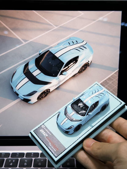 GLAMCRAFT 1:64 Ferrari 812 Competizione Light Blue with White Stripes diecast model car displayed beside full-size Ferrari 812 Competizione