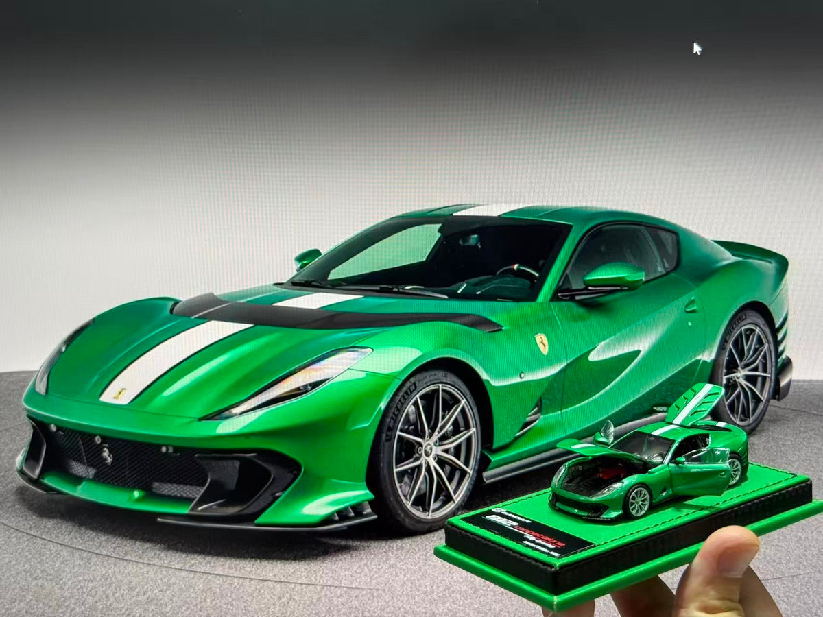 GLAMCRAFT 1:64 Ferrari 812 Competizione Green with White Stripes diecast model car with opening parts displayed beside full-size Ferrari 812 Competizione