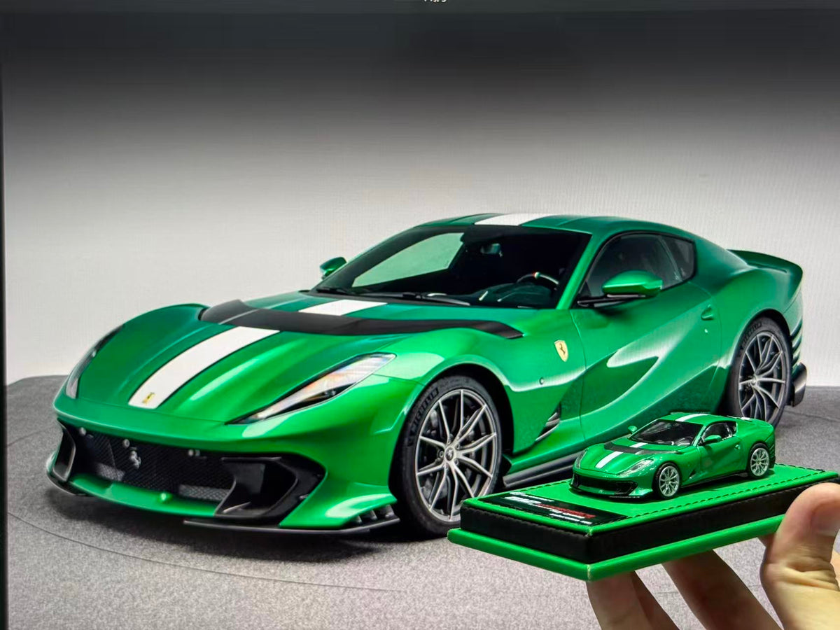 GLAMCRAFT 1:64 Ferrari 812 Competizione Green with White Stripes diecast model car displayed beside full-size Ferrari 812 Competizione