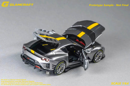 A scale model of a silver sports car with yellow stripes, shown with its doors and hood open on a gray background. The brand 'GLAMERCRAFT' is visible in the top left corner.