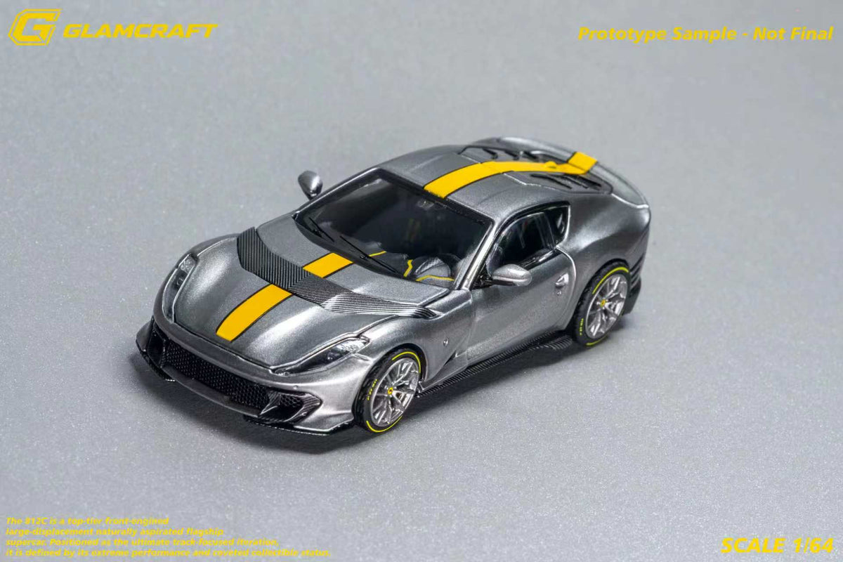 GLAMCRAFT 1:64 Ferrari 812 Competizione Grey with Yellow Stripe diecast model car front three-quarter view with carbon fiber details