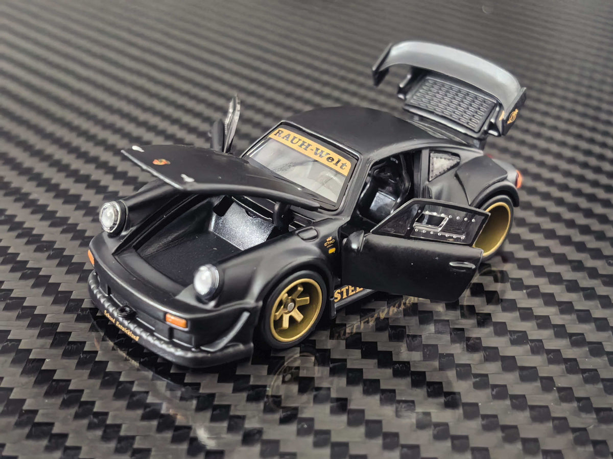HG Model 1:64 RWB 930 Stella Artois Matte Black diecast model featuring opening front hood, side doors and rear engine cover, gold wheels, widebody kit and detailed interior, front three-quarter view.
