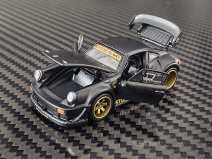 HG Model 1:64 RWB 930 Stella Artois Matte Black diecast model featuring opening front hood, side doors and rear engine cover, gold wheels, widebody kit and detailed interior, front three-quarter view.