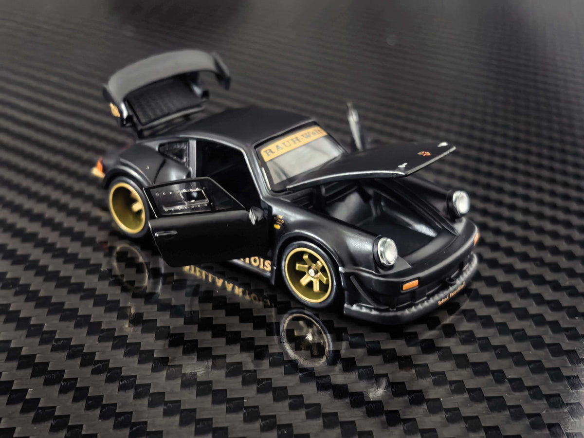 HG Model 1:64 RWB 930 Stella Artois Matte Black diecast model featuring opening front hood, side door and rear engine cover, gold wheels, widebody kit and detailed front bumper, front three-quarter view.