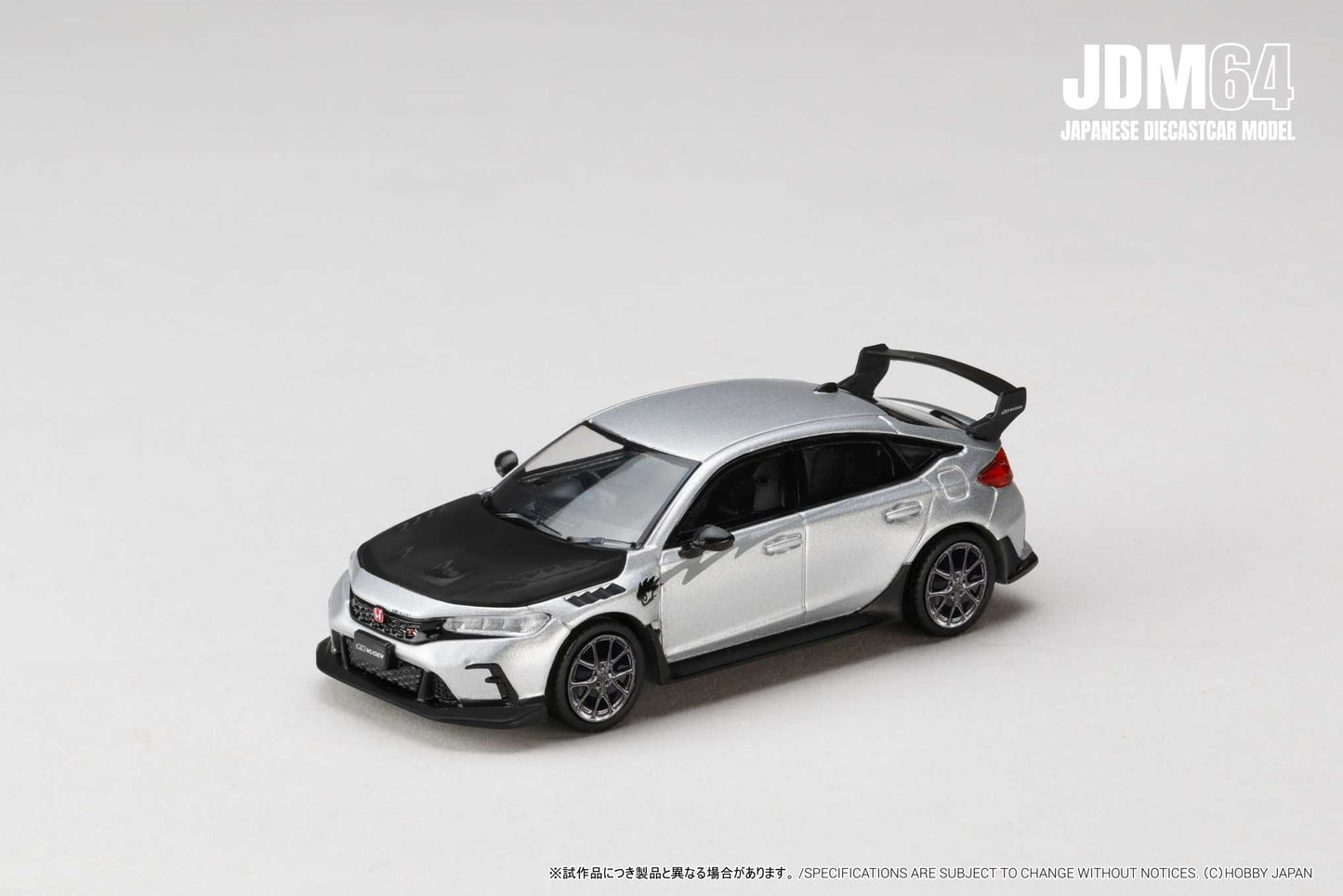 Silver and black diecast model car on a white background, featuring a sporty design with a rear spoiler from the JDM64 Japanese Diecast Model series.
