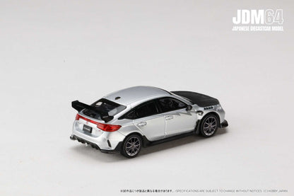 A silver diecast model car with a black hood and rear spoiler, set on a plain white background. The car is a JDM64 Japanese model.