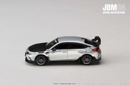 Silver and black diecast model car on a pale background, featuring sporty design with spoiler. Emphasizes sleek lines, modern aesthetic. JDM branding in corner.