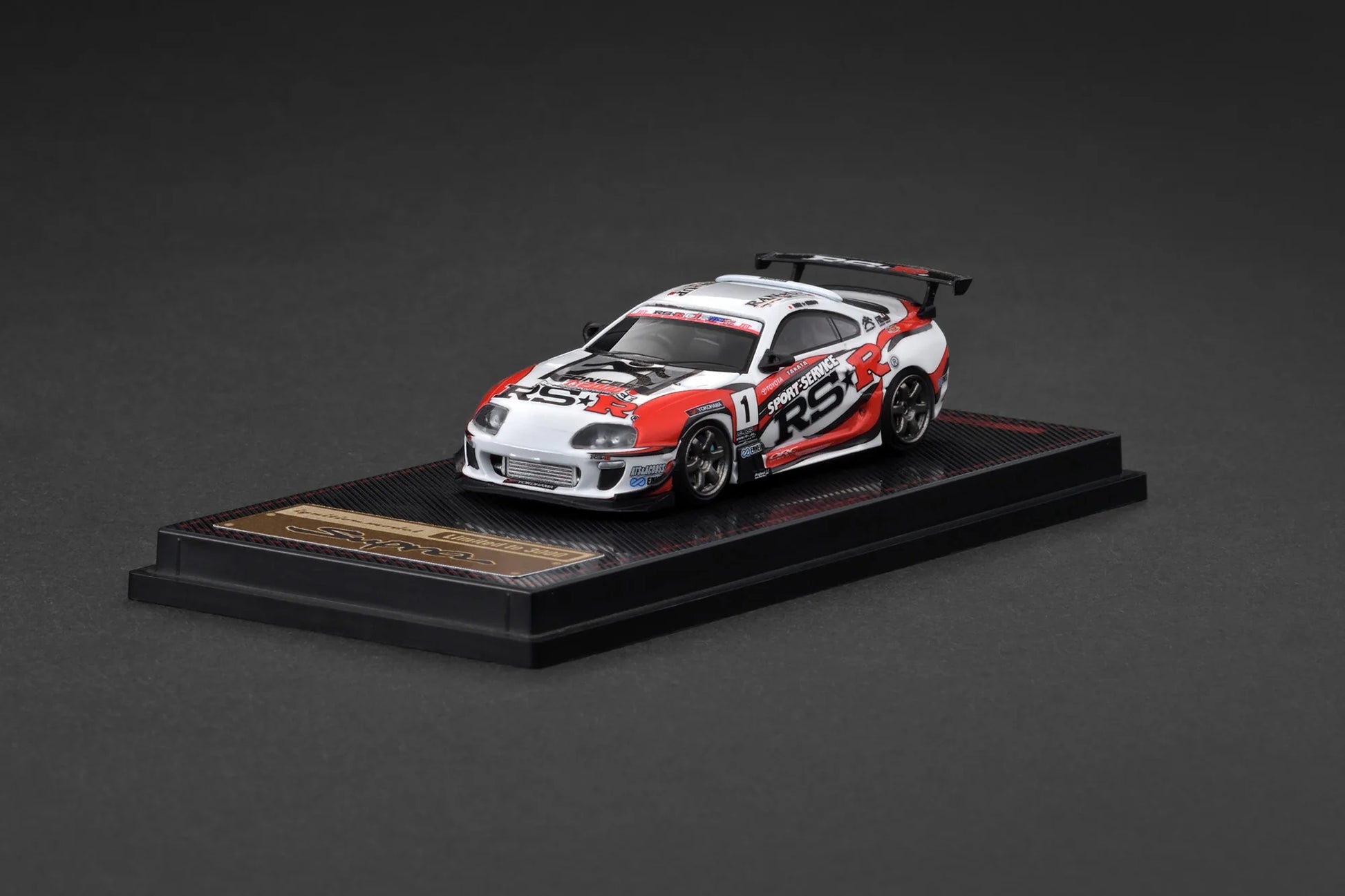 Model car on a display stand with a dark background