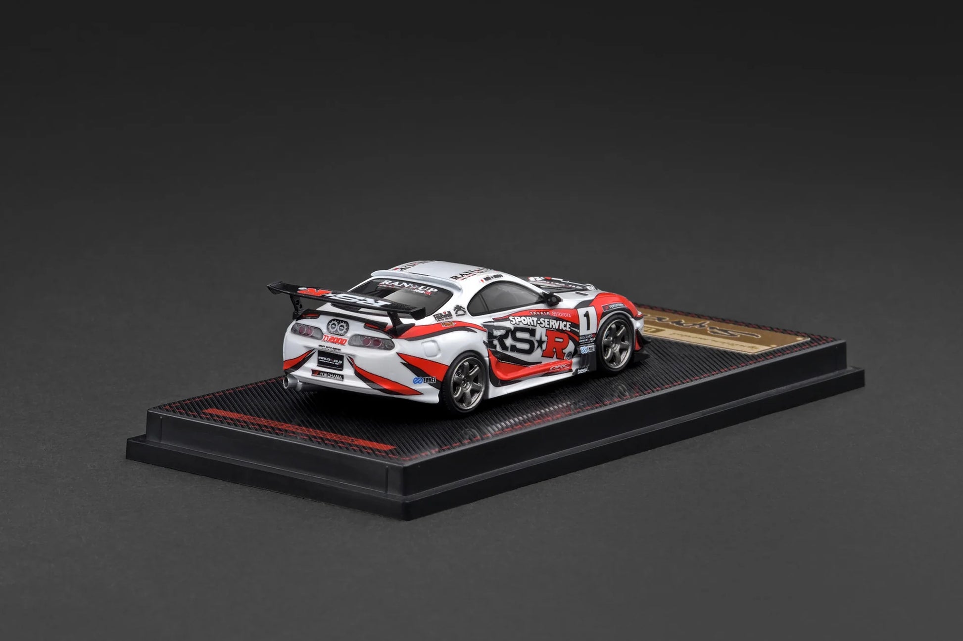 Model car on a display stand with a dark background