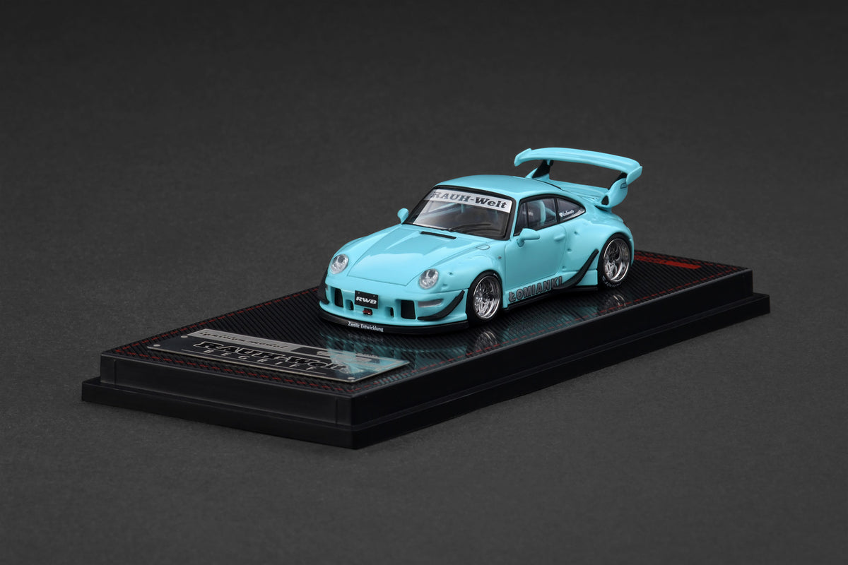 Light blue model car on a black platform with a dark gray background