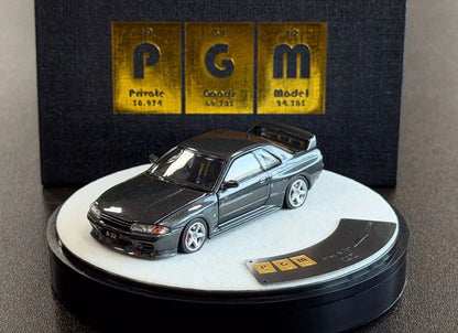 Model car on a display stand with 'PGM' branding
