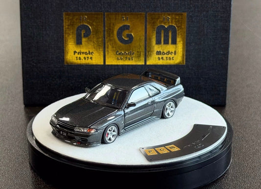 Model car on a display stand with 'PGM' branding