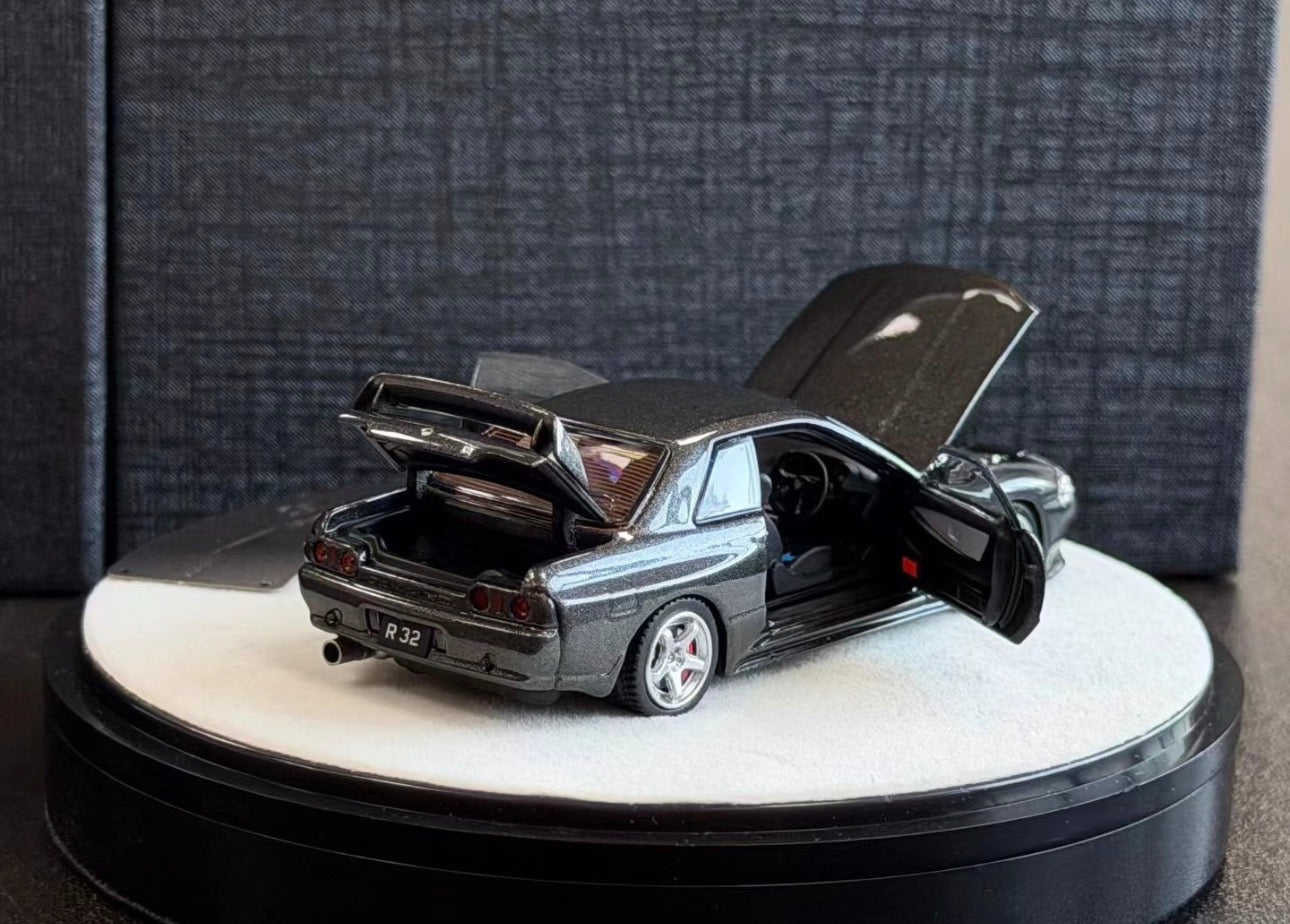Model car with open hood on a white platform against a dark textured background